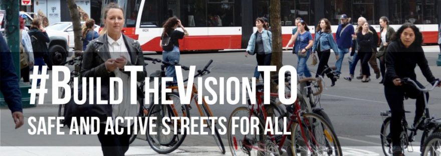 Image of pedestrians, cyclists and streetcar