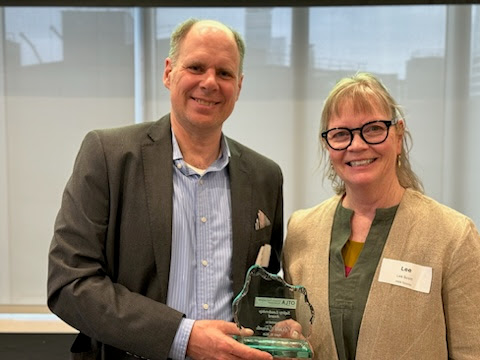 Two people holding award